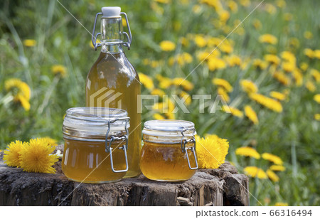 Syrup of their dandelions in glass jars on a 66316494