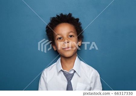 Handsome little black child boy portrait on blue Handsome little black child boy portrait on blue 66317330