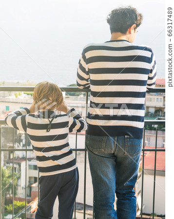 Father and son wearing striped shirts Father and son wearing striped shirts 66317489