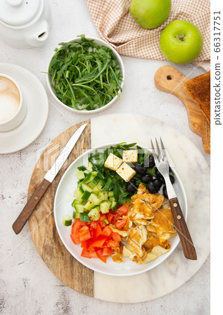 Fresh omelette for breakfast with mixed vegetables, toast brerad and cup of coffee. Top view. Fresh omelette for breakfast with mixed vegetables, toast brerad and cup of coffee. Top view. 66317751