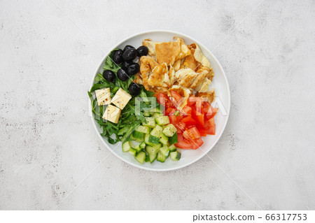 Healthy breakfast. Omelette with fresh mixed vegetables salad rocket, tomatoes, cucumber, olives, cheese. Top view. Healthy breakfast. Omelette with fresh mixed vegetables salad rocket, tomatoes, cucumber, olives, cheese. Top view. 66317753