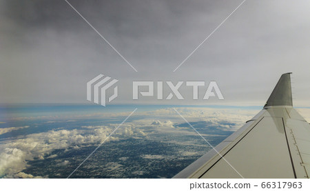 Aerial view of cloud and sky with airplane wing 66317963