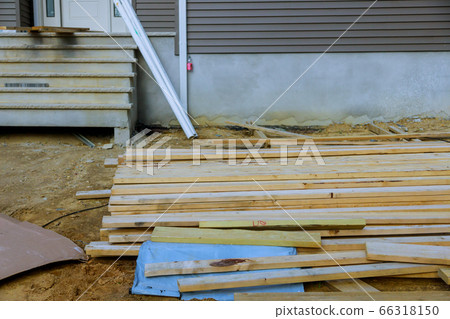 Stack of unloading wooden beams on construction Stack of unloading wooden beams on construction 66318150
