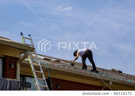 Construction worker roofer builder on roof 66318172