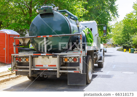 Vacuum waste truck on the cleaning process 66318173