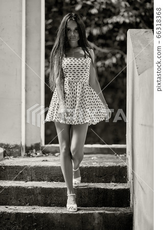 Young model walking on stairs in the ruined 66318368