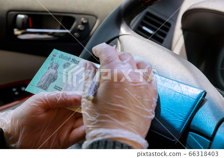 Writing on blank check to in car with gloves on 66318403