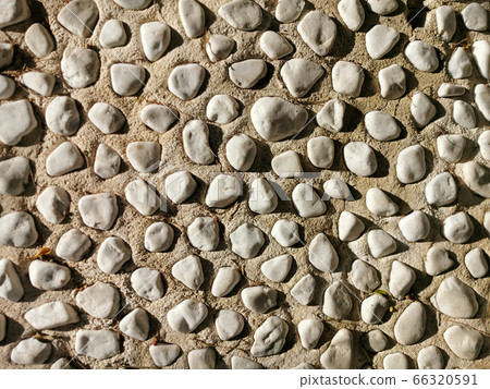 round gray stones in cement as texture, background round gray stones in cement as texture, background 66320591
