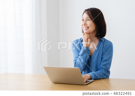 Middle-aged woman using a computer 66322491