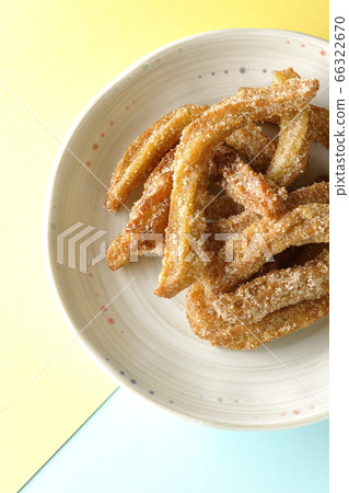 Churros with plenty of cinnamon sugar taken from the studio, overhead view using two light colors Churros with plenty of cinnamon sugar taken from the studio, overhead view using two light colors 66322670