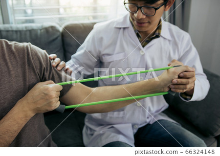 Asian male physical therapist descent working and 66324148