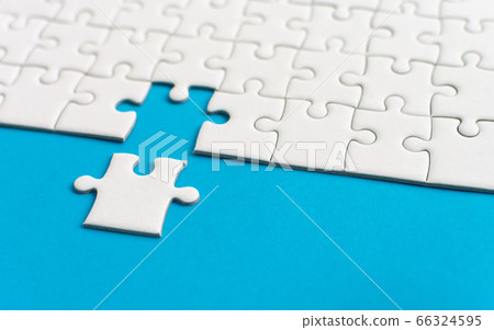 White jigsaw puzzle on blue background. Team business success partnership or teamwork. White jigsaw puzzle on blue background. Team business success partnership or teamwork. 66324595