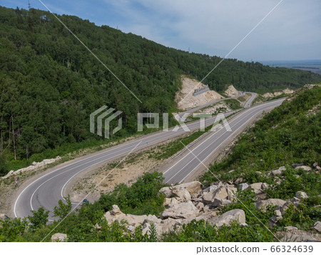 Aerial top vew of winding road in the mountains Aerial top vew of winding road in the mountains 66324639