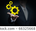Close up of businessman holding gear mechanism in 66325668