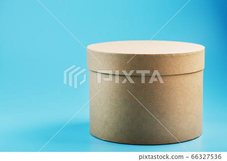 Round cardboard box on a blue background, free Round cardboard box on a blue background, free 66327536