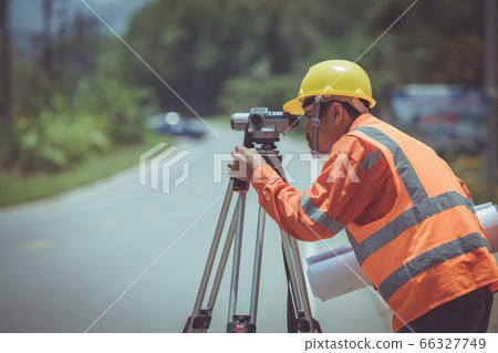 Surveyor engineers work on road construction. 66327749