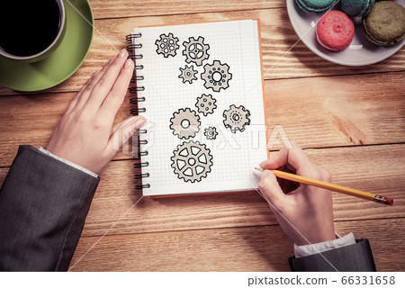 Businesswoman sketching in notepad Businesswoman sketching in notepad 66331658