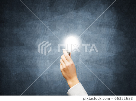 Businesswoman holding in hand glowing light bulb Businesswoman holding in hand glowing light bulb 66331688
