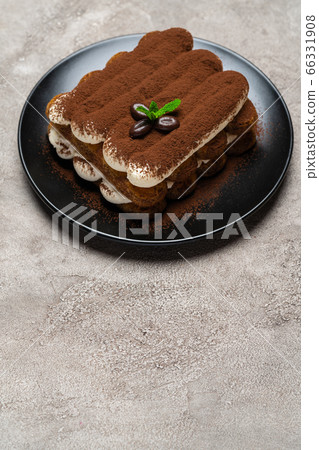 Classic tiramisu dessert on ceramic plate on light grey concrete background 66331908