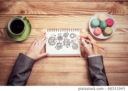 Businesswoman sketching in notepad 66331943