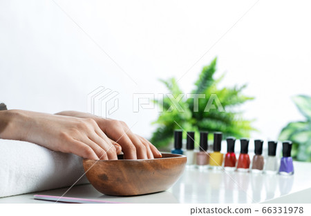 Closeup female hands in wooden bowl with water 66331978