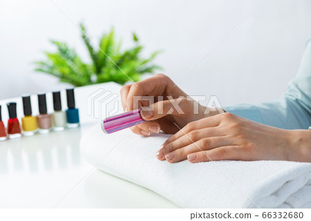 Woman using nail file and create nails shape Woman using nail file and create nails shape 66332680