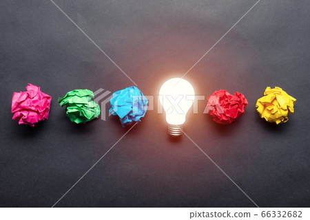 Lightbulb and crumpled colorful paper balls 66332682