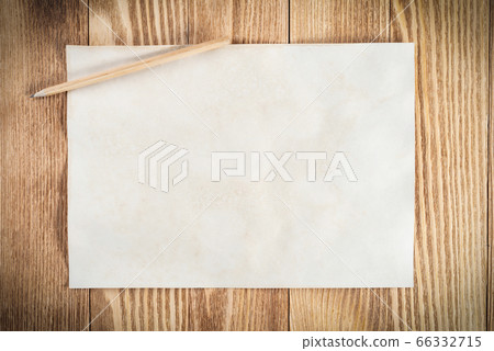 Sheet of paper lying on wooden table 66332715