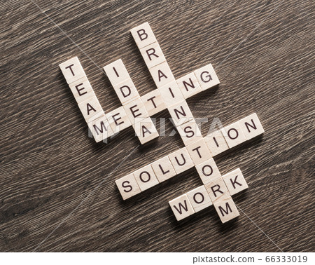 Conceptual business keywords on table with elements of game making crossword 66333019