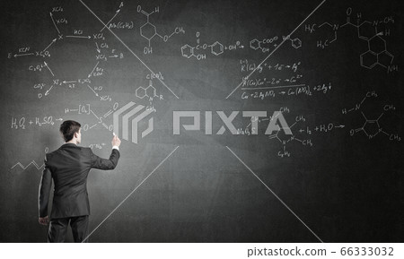 Scientist writing formulas on chalkboard Scientist writing formulas on chalkboard 66333032