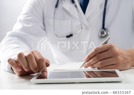 Close up of doctor hands using tablet computer 66333167