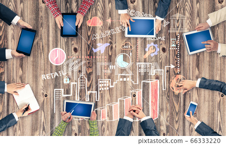 Top view of businesspeople sitting at table and using gadgets 66333220