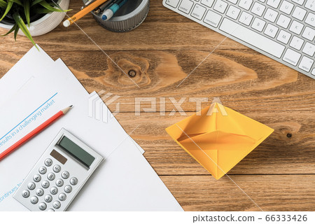 Top view office workspace with orange paper ship Top view office workspace with orange paper ship 66333426