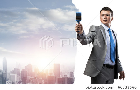 Creative businessman painter holding paintbrush Creative businessman painter holding paintbrush 66333566