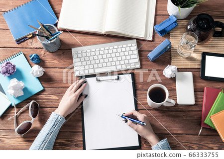 Businesswoman writing on white paper with pen Businesswoman writing on white paper with pen 66333755