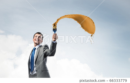 Creative businessman painter holding paintbrush Creative businessman painter holding paintbrush 66333779