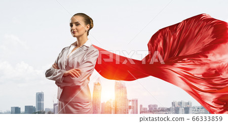 Concept of power and sucess with businesswoman superhero in big city 66333859