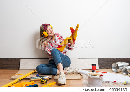 Happy girl in protective headphones and gloves 66334185