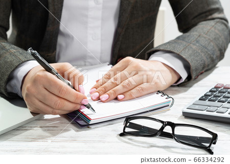 Close up woman hand holding pen Close up woman hand holding pen 66334292