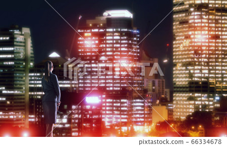 Woman looking at night city Woman looking at night city 66334678