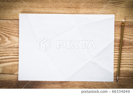 Sheet of paper lying on wooden table Sheet of paper lying on wooden table 66334849