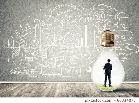 Businessman trapped in bulb 66334875