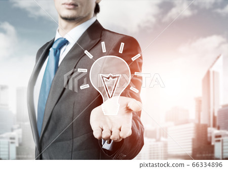 businessman holding creativity icon 66334896
