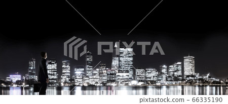 Businessman viewing night glowing city 66335190