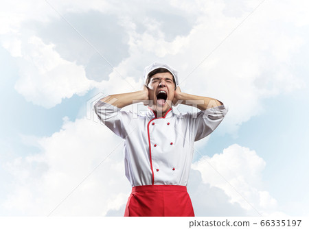 Young male chef screaming in shock and horror 66335197