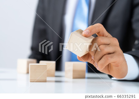 Businessman making tower 66335291