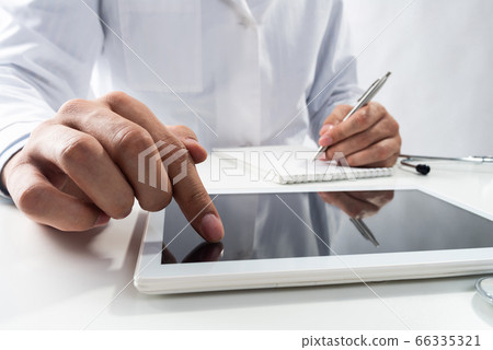 Close up of therapist hands using tablet computer Close up of therapist hands using tablet computer 66335321