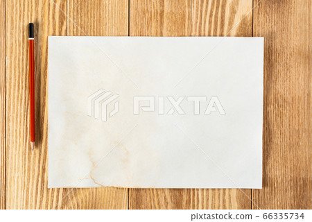 Sheet of paper lying on wooden table 66335734