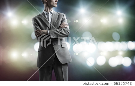 Confident businessman in bokeh lights Confident businessman in bokeh lights 66335748