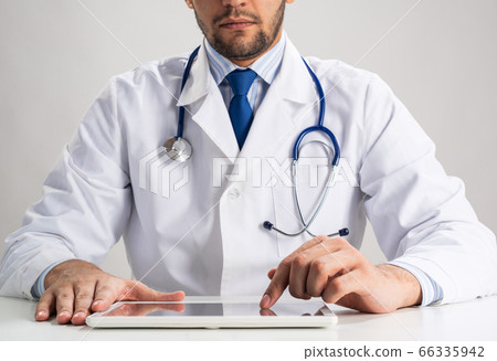 Close up of therapist hands using tablet computer Close up of therapist hands using tablet computer 66335942